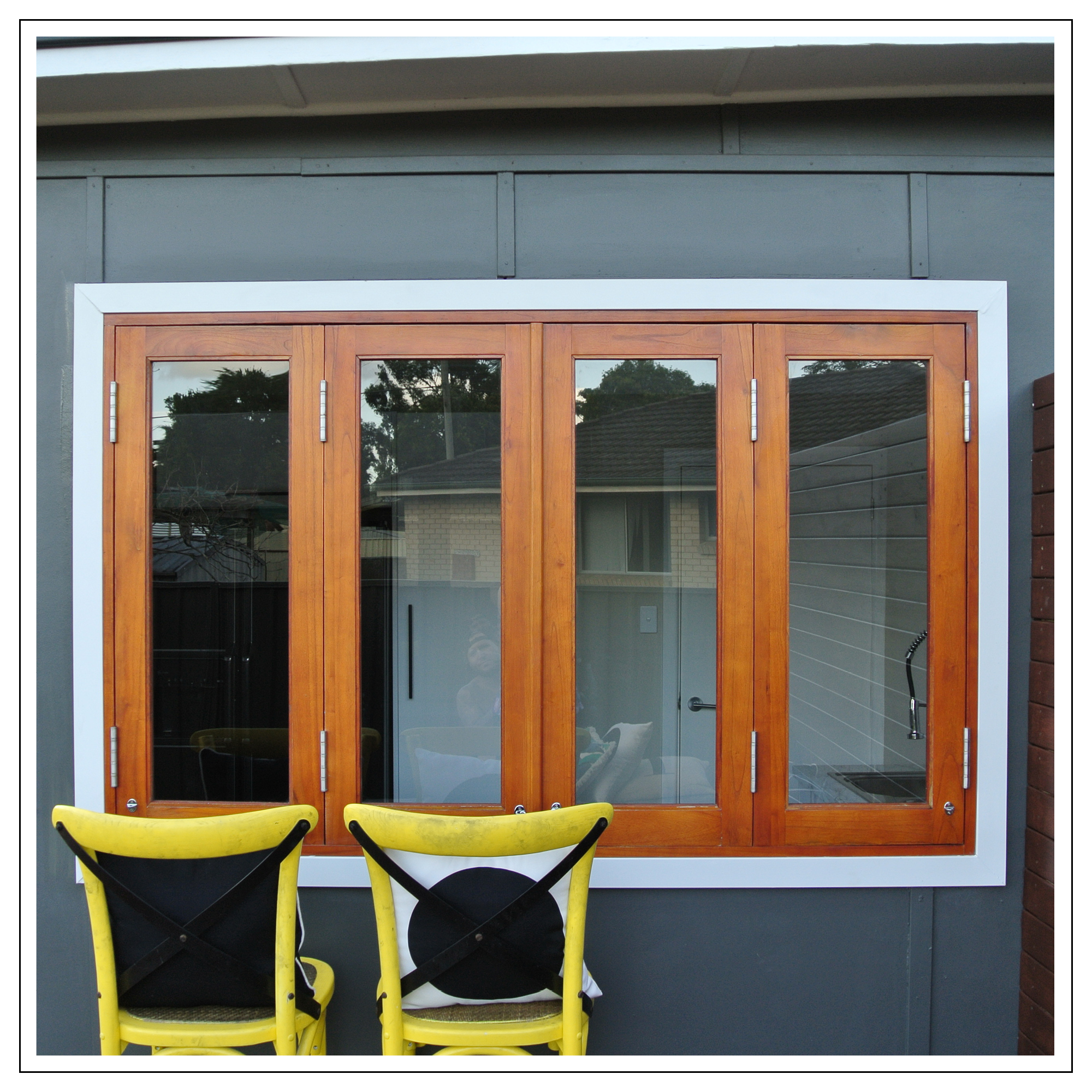 Cedar timber 4 panel bi fold french Window kitchen servery with white architraves