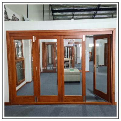 Cedar Timber Clear Glass 4 Panel Bi Fold Stacking Door in showroom with active door open